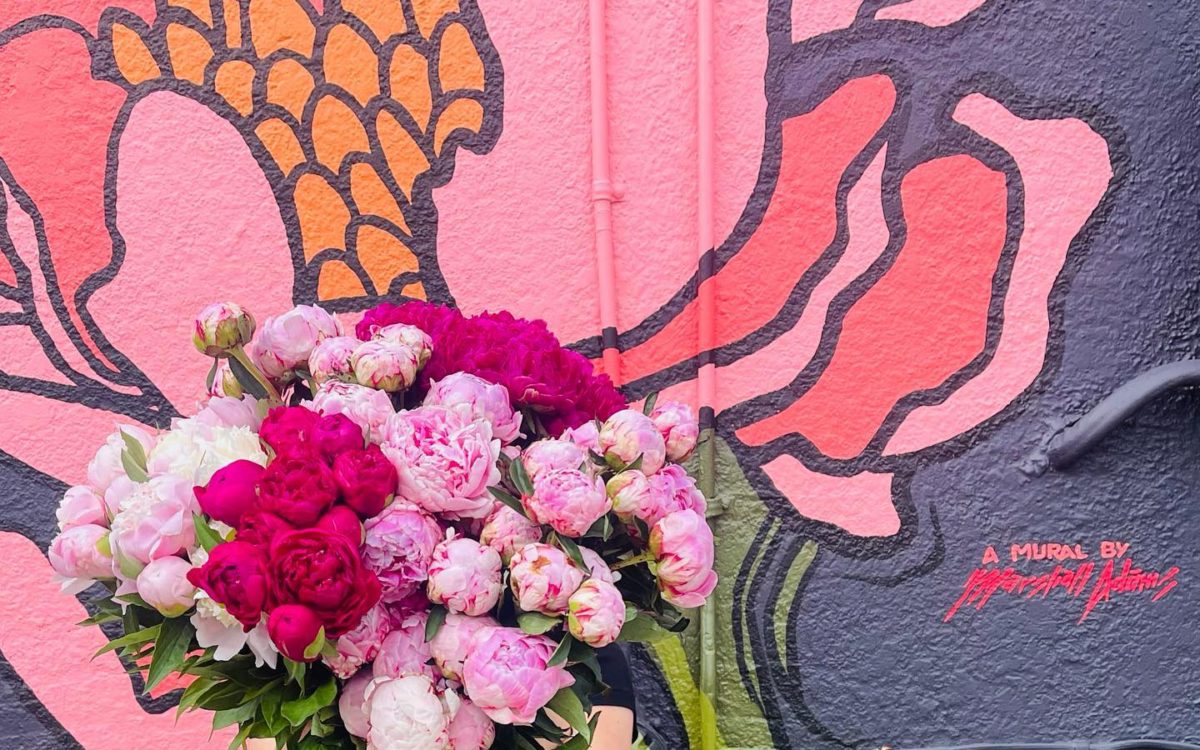 Woman holds pink bouquet of flowers