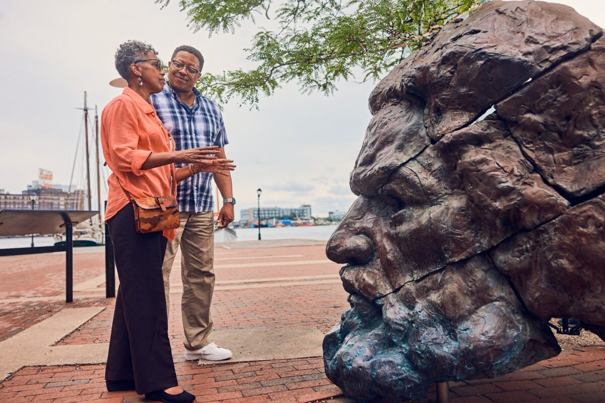 2 people looking at a sculpture