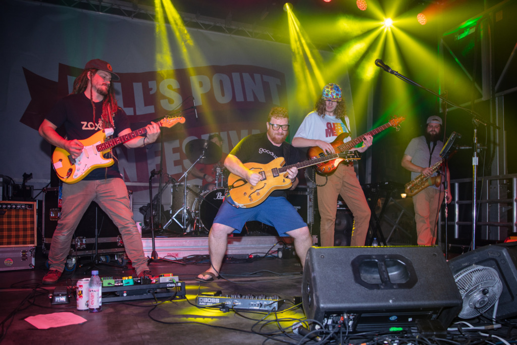 three guitarists on stage