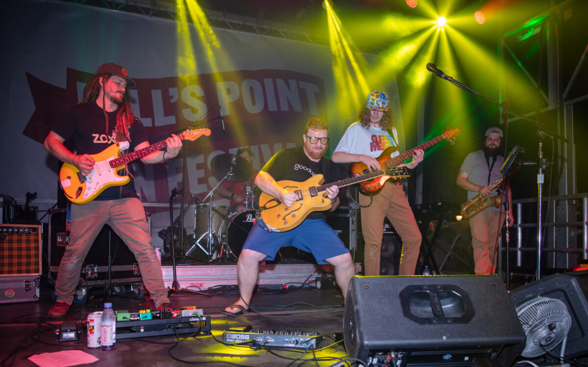 three guitarists on stage