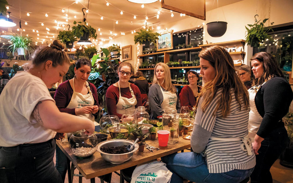 Students sit around a table making plants during a class at B Willow Store in Baltimore.