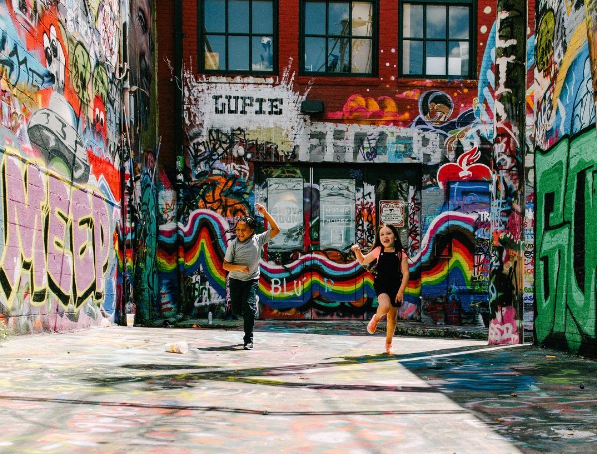 Kids play in graffiti alley