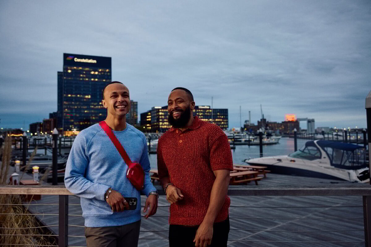 two men posing on a pier