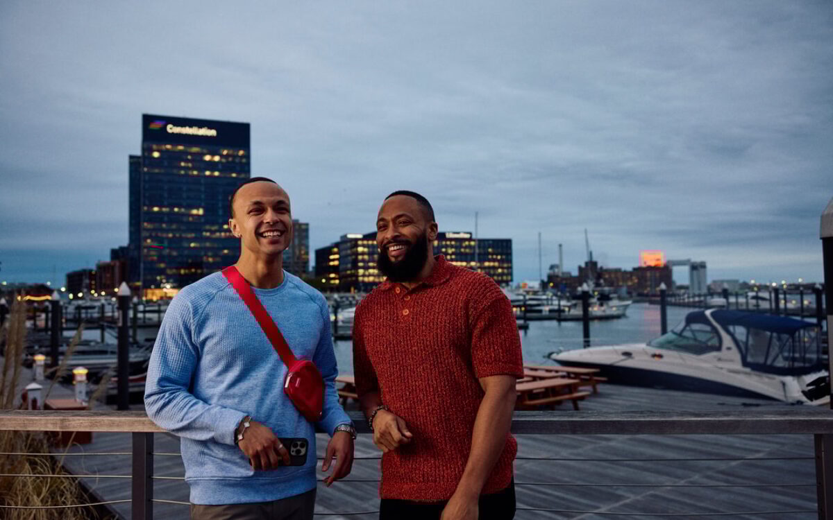 two men posing on a pier