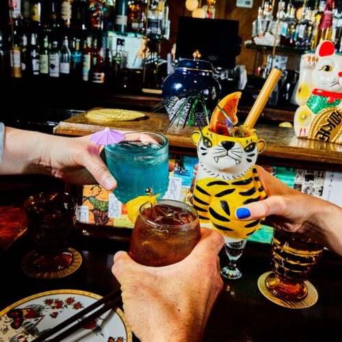 Hands holding cocktails