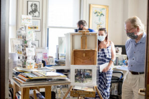 A man and woman admire a canvas in an artists' studio inside Bromo Tower.