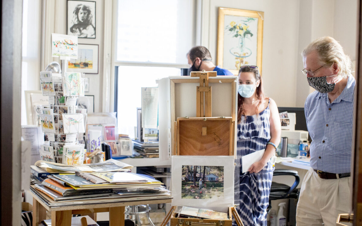 A man and woman admire a canvas in an artists' studio inside Bromo Tower.