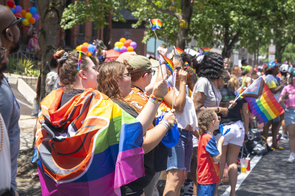A colorful crowd in rainbow clothing