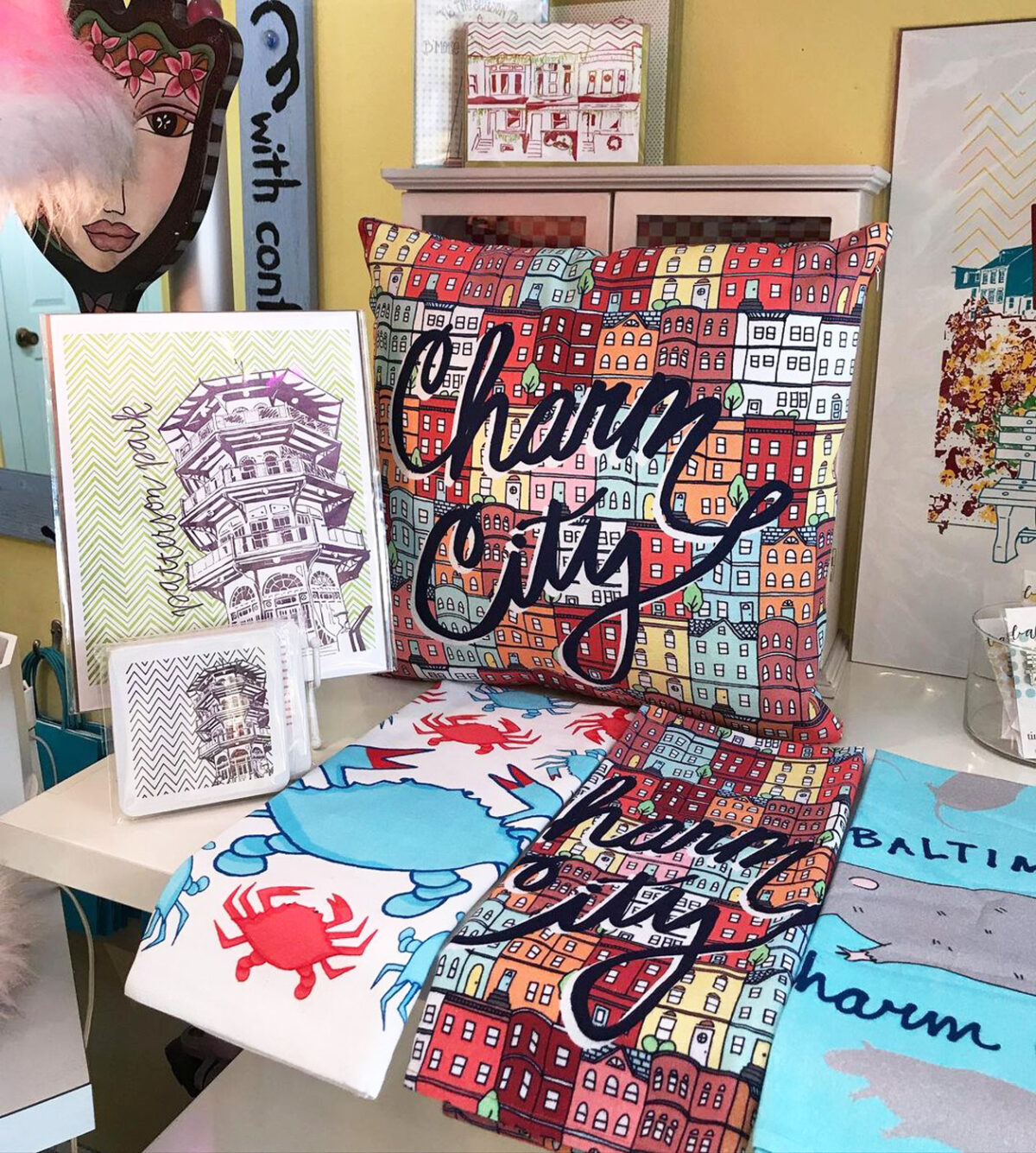 A display of towels and post cards with patterns and designs relating to Baltimore.