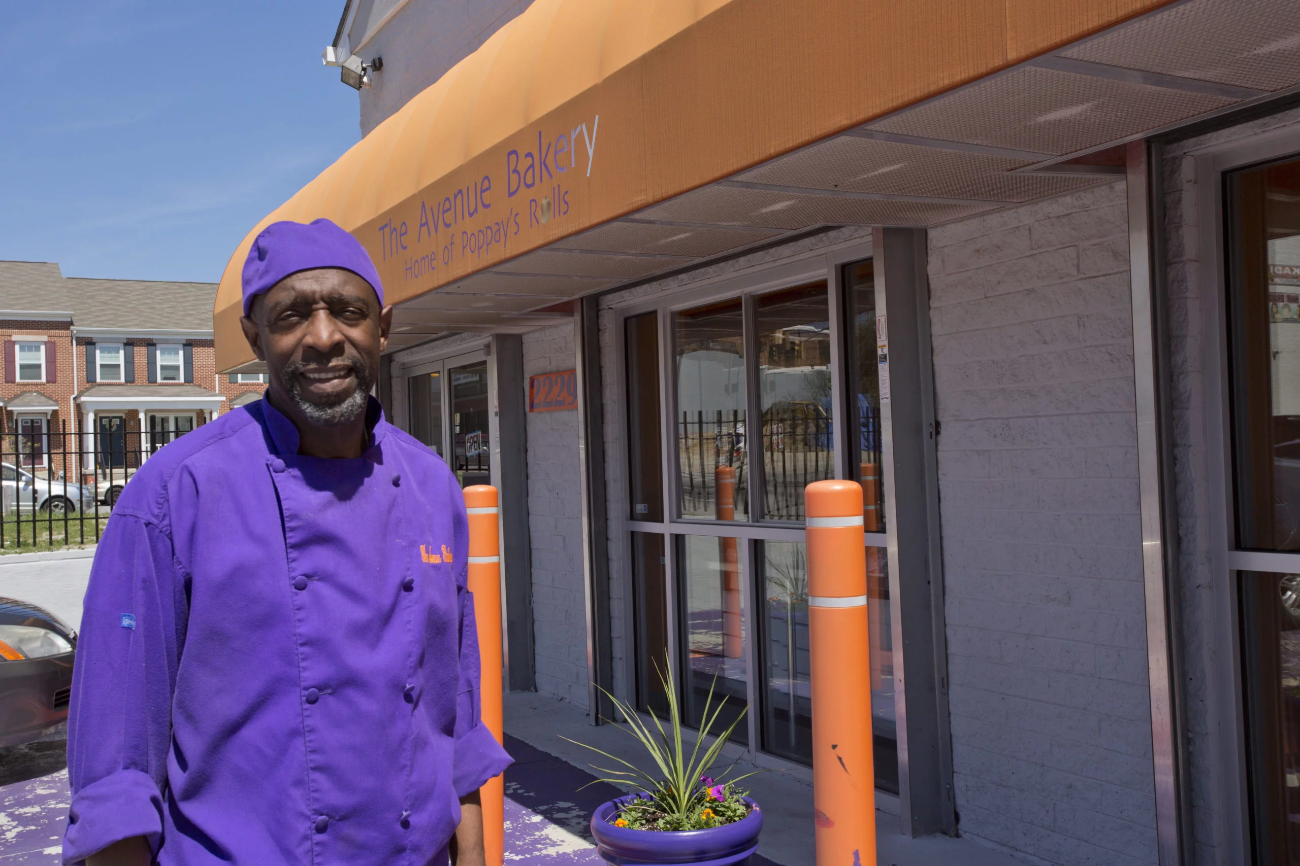 Man standing in front of bakery building