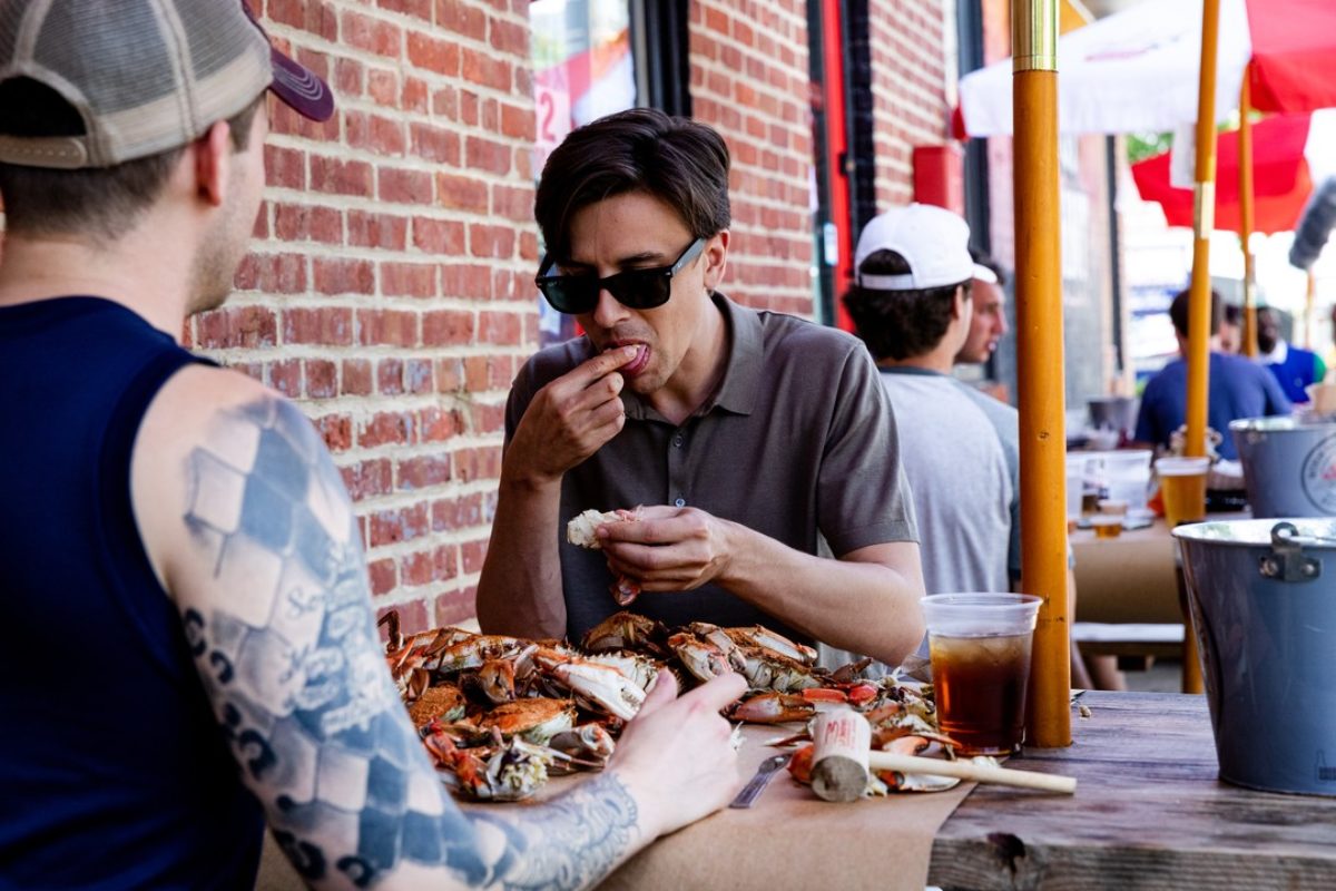 People outside eating crabs
