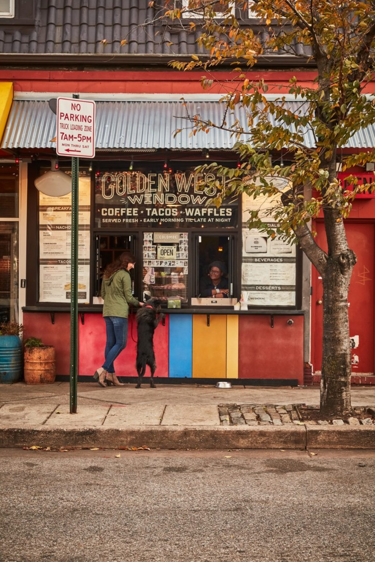 Woman and her dog order from the window at Golden West Cafe