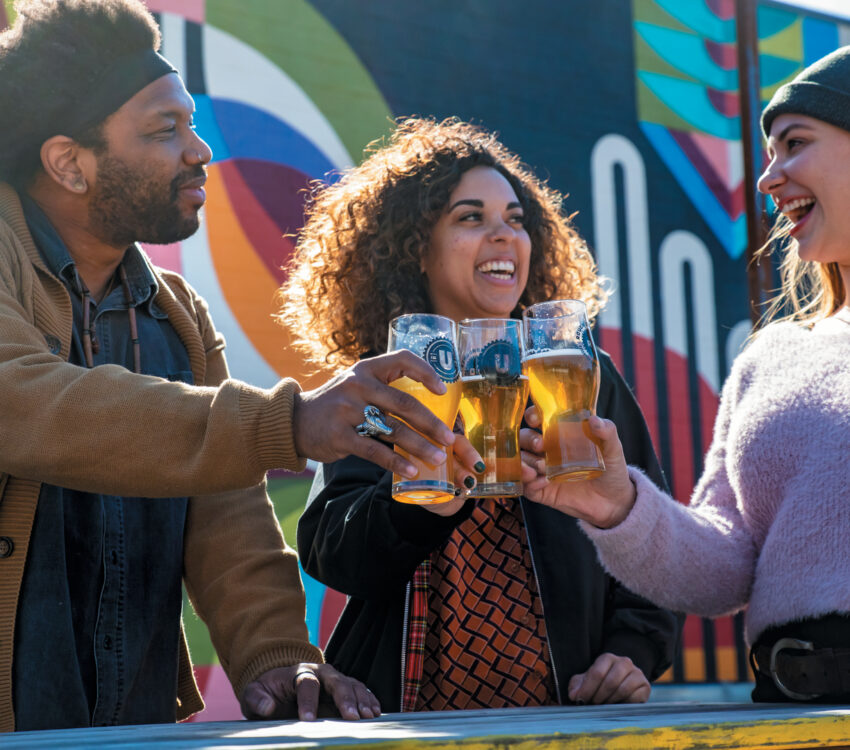 People clinking beer glasses