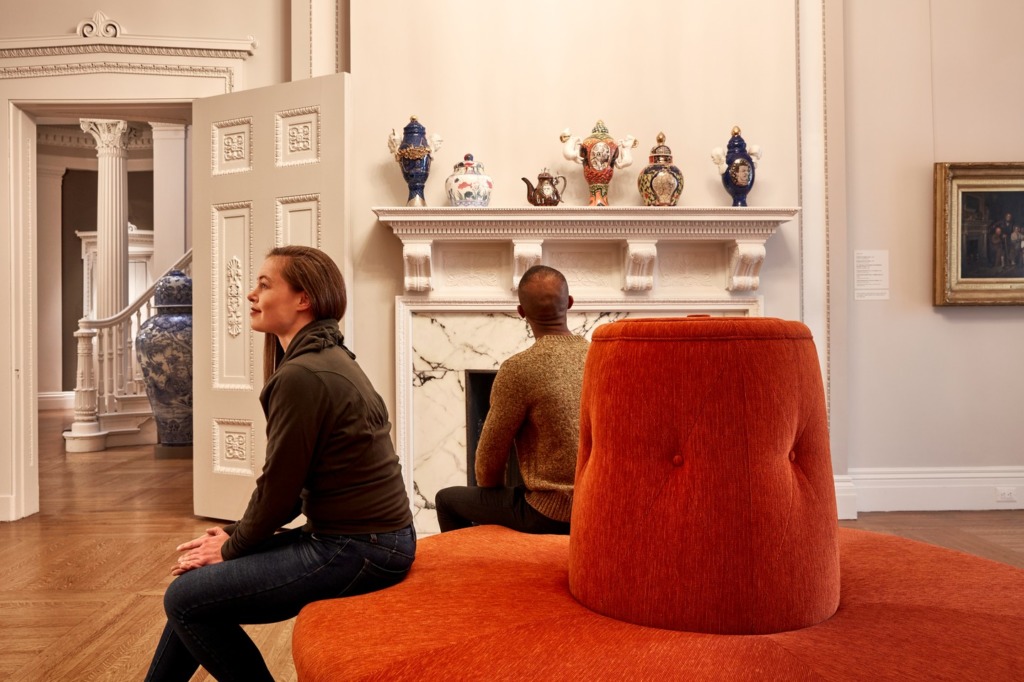 A man and woman admire pottery at the Walters Art Museum