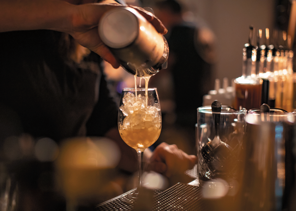 Justin Tsucalas Pouring a cocktail at Old Line Spirits